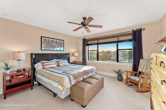 bedroom featuring ceiling fan and carpet