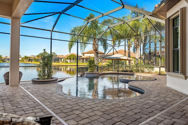 view of swimming pool with a patio, a water view, and glass enclosure