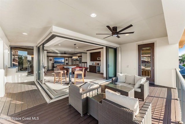 deck featuring outdoor lounge area and ceiling fan