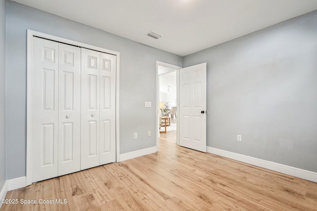 unfurnished bedroom featuring a closet and light hardwood / wood-style flooring