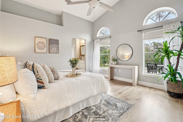 bedroom with high vaulted ceiling, light hardwood / wood-style floors, and ceiling fan