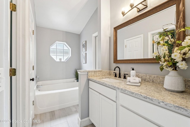 bathroom featuring vanity and a tub