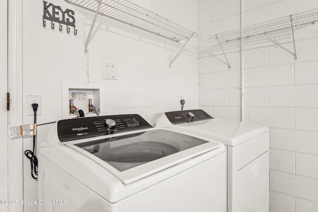 clothes washing area featuring washer and dryer