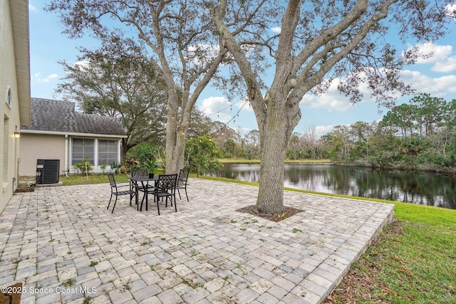 view of patio with a water view and cooling unit