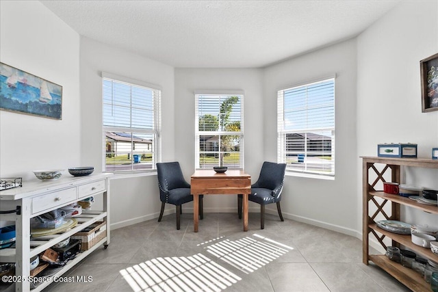 sitting room with light tile patterned floors and a textured ceiling