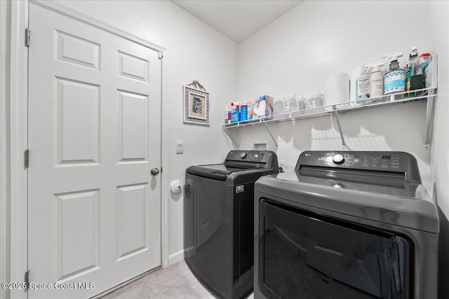 clothes washing area featuring independent washer and dryer and light tile patterned floors