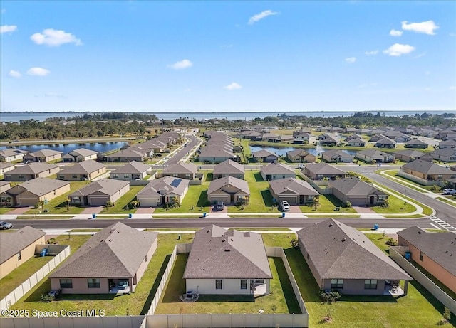 birds eye view of property featuring a water view