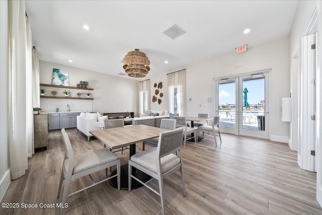 dining room with french doors and light wood-type flooring