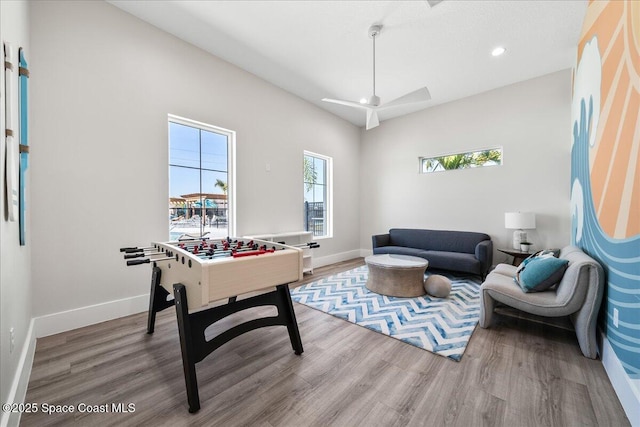 playroom with hardwood / wood-style flooring and ceiling fan