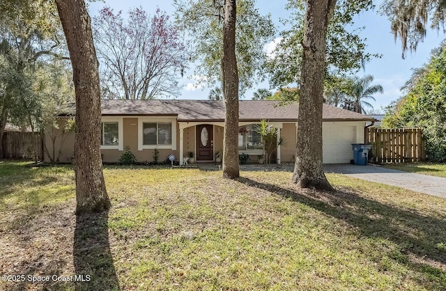 ranch-style home featuring a garage and a front lawn