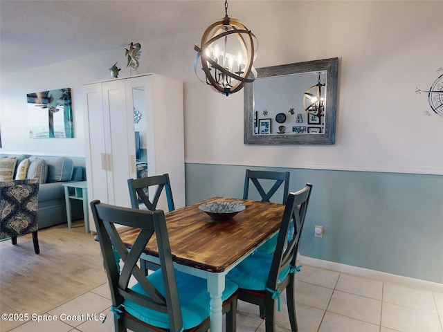 dining area featuring an inviting chandelier and light tile patterned floors