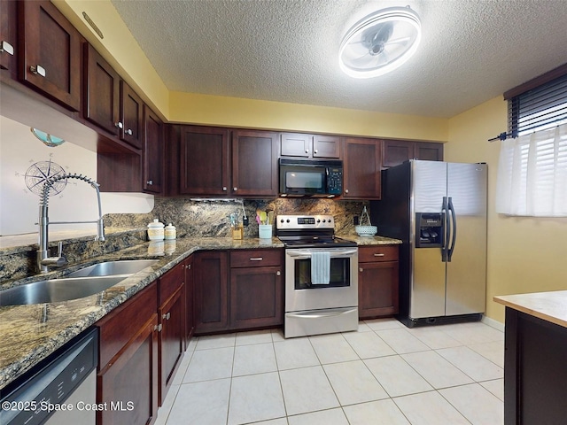 kitchen featuring light tile patterned flooring, appliances with stainless steel finishes, sink, backsplash, and light stone countertops