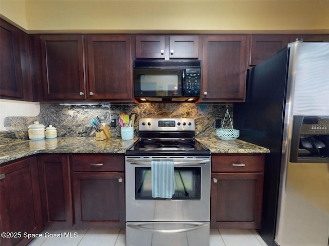 kitchen with stainless steel appliances, light tile patterned floors, light stone counters, and decorative backsplash