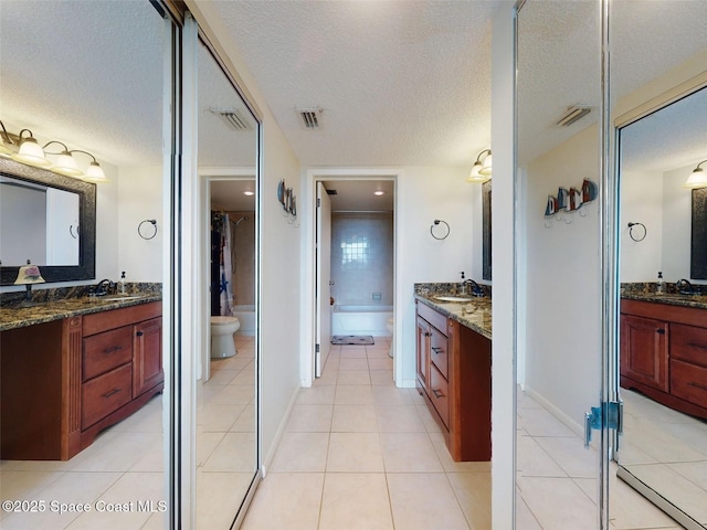 full bathroom with vanity, shower with separate bathtub, tile patterned floors, and a textured ceiling