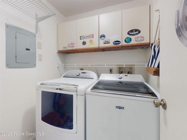 laundry area with washing machine and clothes dryer and electric panel