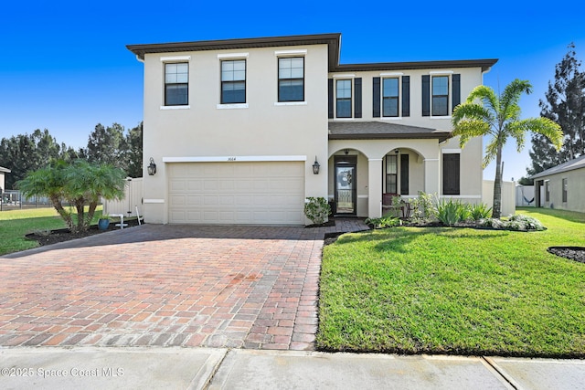 view of front of home featuring a garage and a front lawn