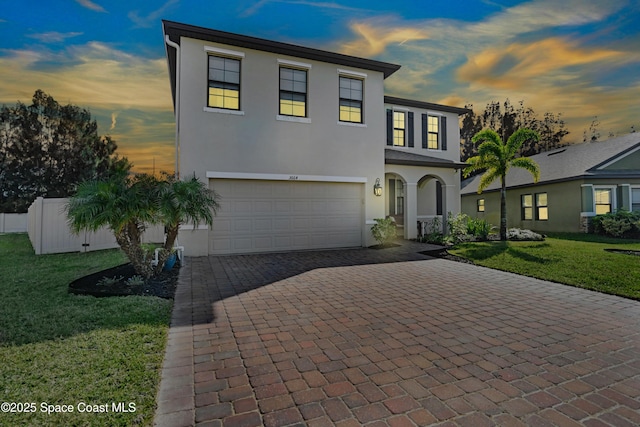 view of front of home featuring a garage and a lawn