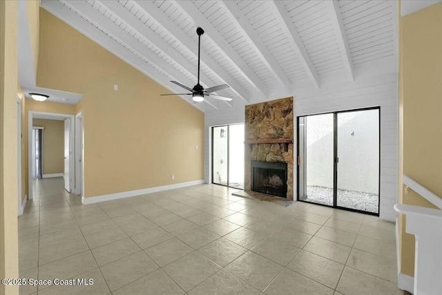 unfurnished living room with a fireplace, high vaulted ceiling, beam ceiling, and light tile patterned floors