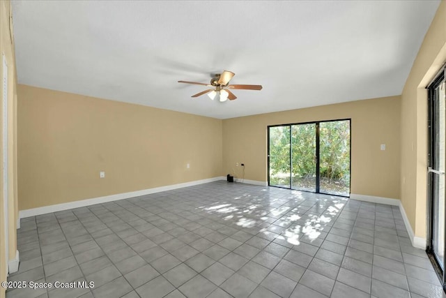 tiled spare room featuring ceiling fan