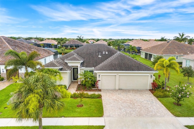 view of front of house with a garage and a front yard