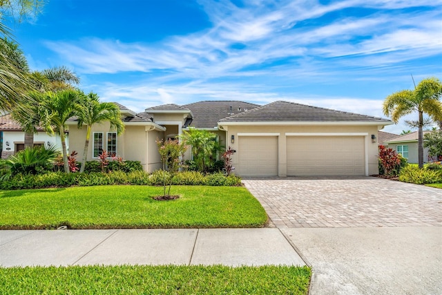 view of front of property with a garage and a front yard