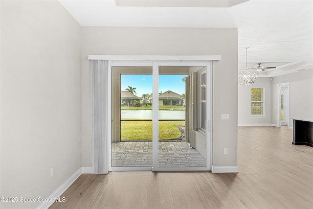 entryway featuring a water view and light hardwood / wood-style floors