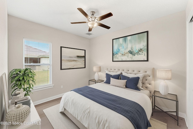 bedroom featuring wood-type flooring and ceiling fan