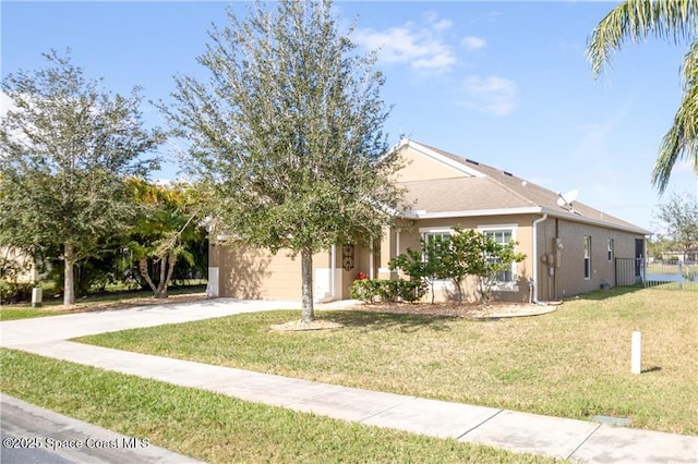 view of front of house with a garage and a front yard