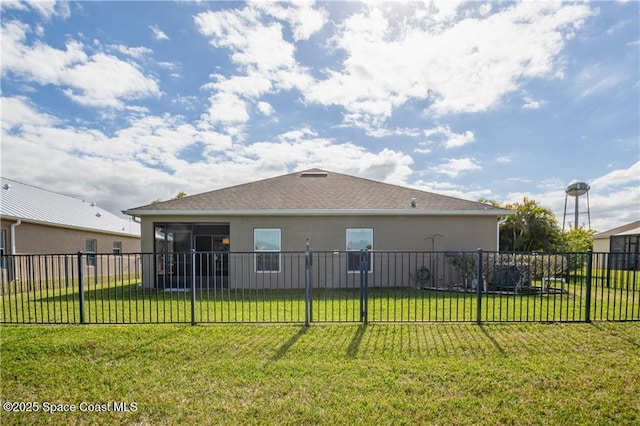 back of house with a yard and a sunroom