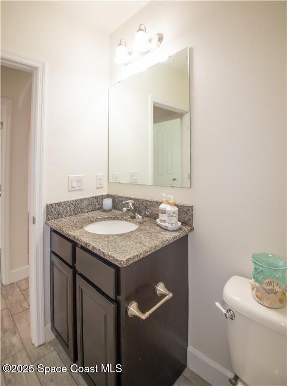 bathroom featuring vanity and toilet