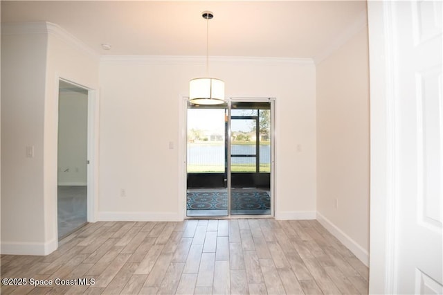 empty room featuring light hardwood / wood-style flooring and ornamental molding