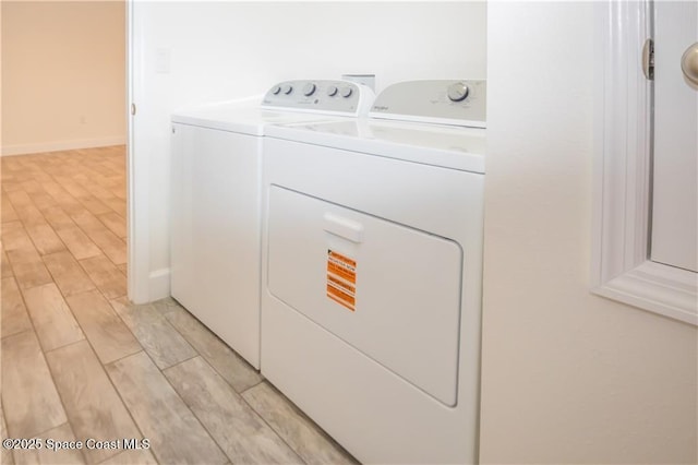 laundry area with washing machine and clothes dryer