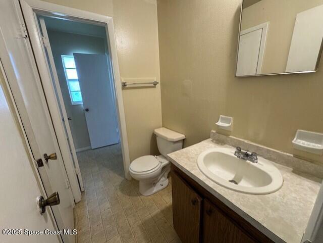 bathroom featuring toilet and vanity