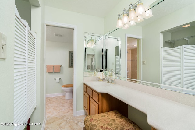 bathroom featuring vanity, toilet, and tile patterned flooring