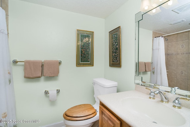 bathroom featuring a shower with curtain, vanity, a textured ceiling, and toilet