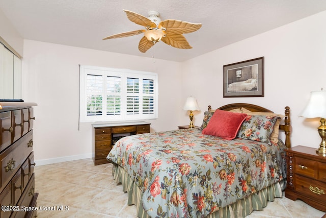 tiled bedroom with ceiling fan