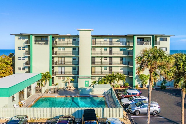 view of property featuring a community pool and a water view