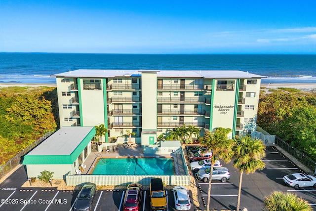 drone / aerial view featuring a beach view and a water view