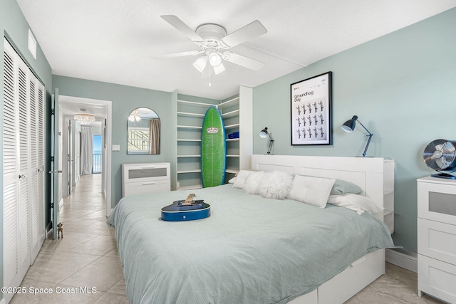 bedroom featuring ceiling fan, a closet, and light tile patterned floors