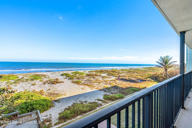 balcony with a water view and a beach view