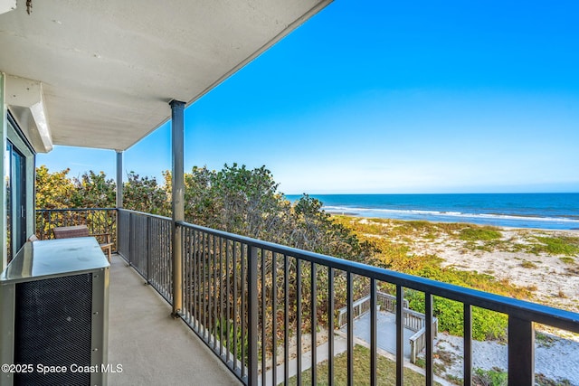 balcony with a view of the beach and a water view