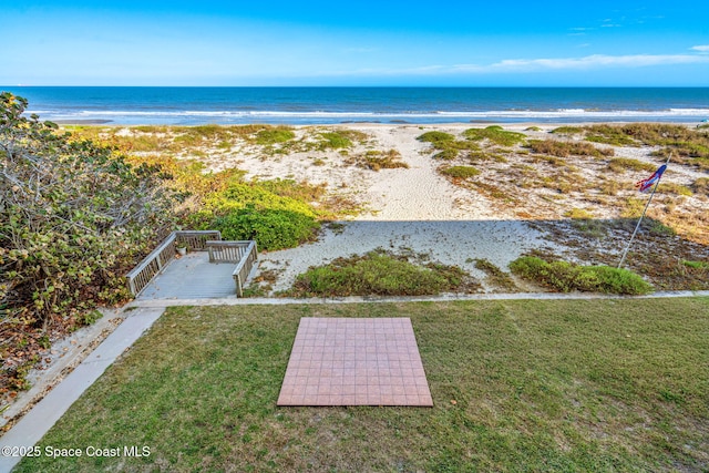 bird's eye view with a water view and a beach view