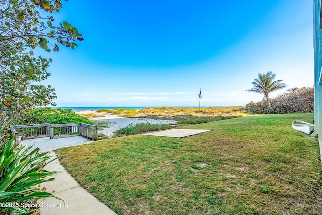 view of yard with a water view and a patio area