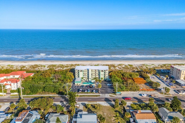 birds eye view of property featuring a water view and a beach view