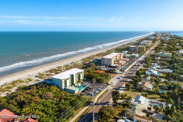 drone / aerial view featuring a water view and a beach view