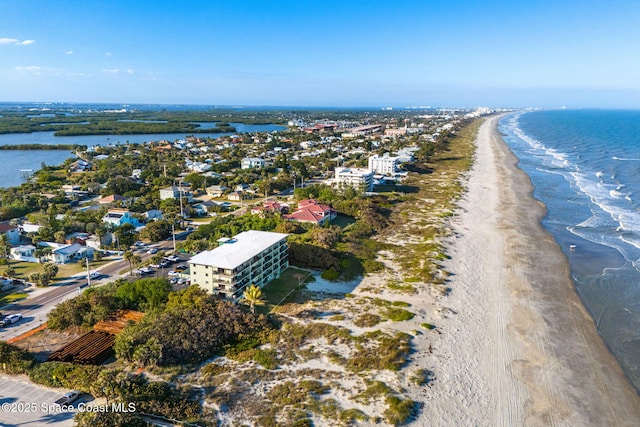 aerial view with a water view and a beach view