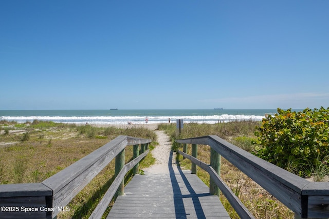 view of home's community with a beach view and a water view