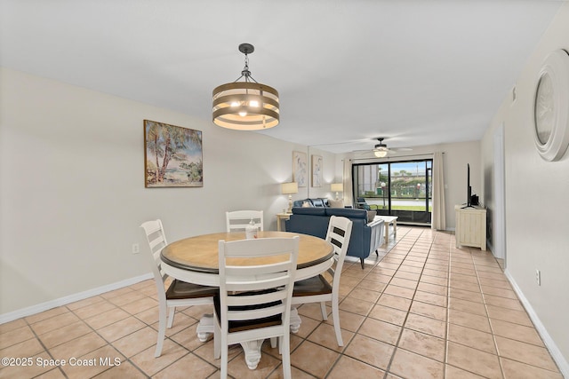 dining space featuring light tile patterned floors and ceiling fan