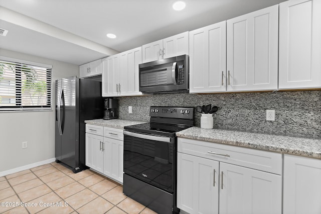 kitchen with white cabinetry, light stone counters, decorative backsplash, and black appliances