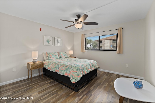 bedroom with dark hardwood / wood-style flooring and ceiling fan